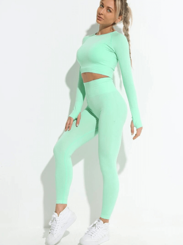 Woman wearing a stylish elastic suit with top and leggings in mint green, perfect for yoga and workouts. SF1683